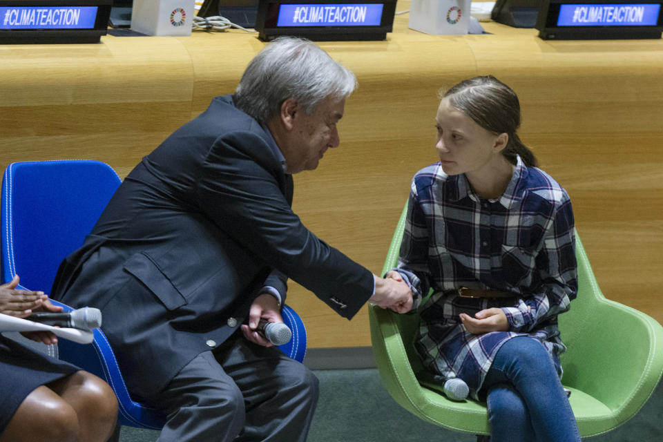 FILE - In this Saturday, Sept. 21, 2019 file photo Swedish environmental activist Greta Thunberg, right, shakes hands with U.N. Secretary-General Antonio Guterres, during the Youth Climate Summit at United Nations headquarters. In a wide-ranging monologue on Swedish public radio, teenage climate activist Greta Thunberg recounts how world leaders queued up to have their picture taken with her even as they shied away from acknowledging the grim scientific fact that time is running out to curb global warming. (AP Photo/Eduardo Munoz Alvarez, file)