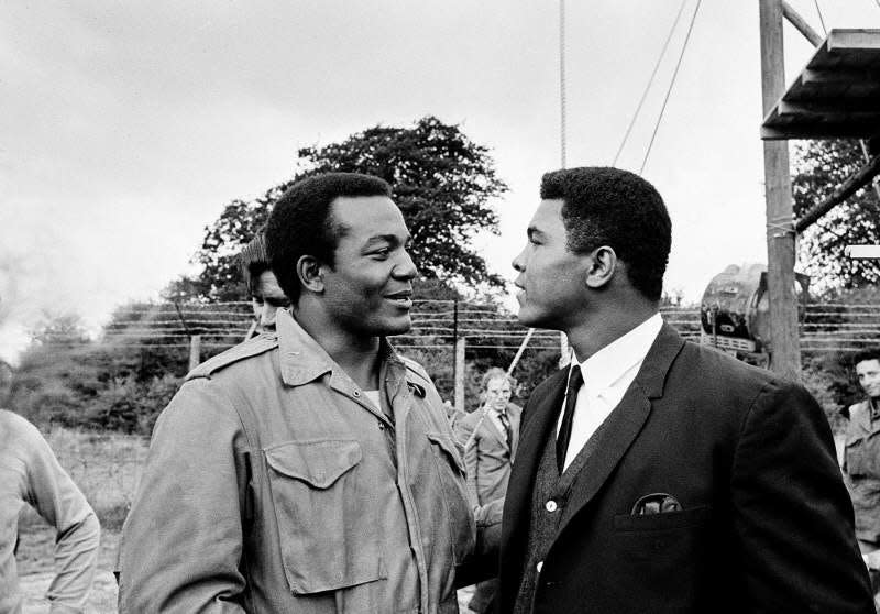 Muhammad Ali visits Cleveland Browns running back and actor Jim Brown on the film set of movie "The Dirty Dozen" at Morkyate, Bedfordshire, England, on Aug. 5, 1966.