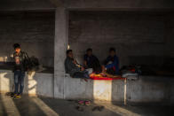 Police officers who fled Myanmar following a military coup rests at an undisclosed location bordering Myanmar, in the northeastern Indian state of Mizoram, Thursday, March 18, 2021. Villagers in Mizoram have given shelter to 34 Myanmar police personnel and 1 fire fighter, who crossed over to the state over the last two weeks. Those who escaped spend their time watching local television and doing daily chores. Some of them have carried mobile phones and are trying to connect to families they were forced to leave behind. At night, all of them go to sleep on mattresses laid on the floor of a single room. (AP Photo/Anupam Nath)