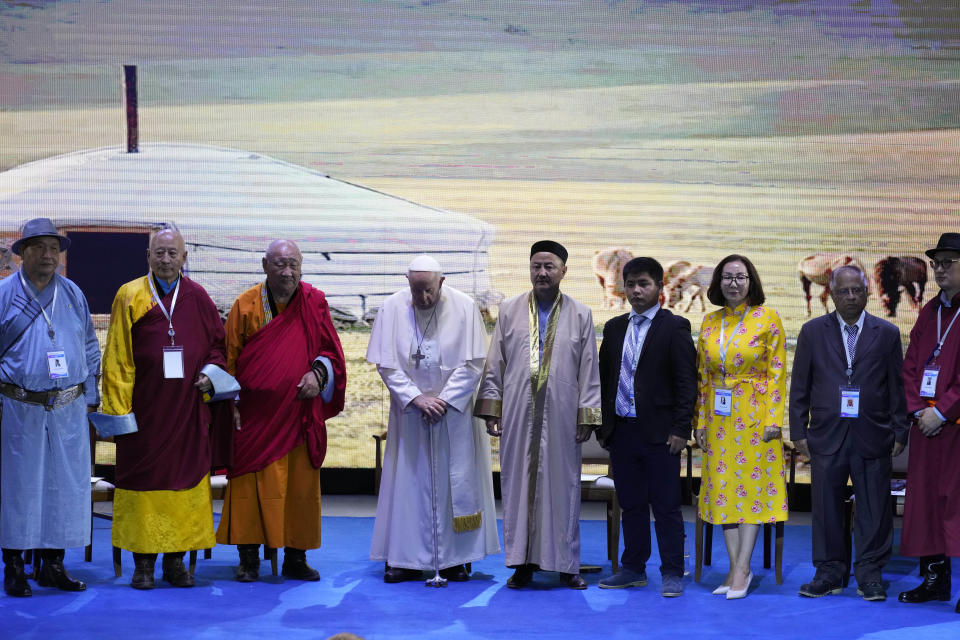 Religious leaders with Pope Francis, 4th from left, pose for a family photo at the end of a meeting at the Hun Theatre in the Sky Resort compound some 15 kilometers south of the Mongolian capital Ulaanbaatar, Sunday, Sept. 3, 2023. Pope Francis has praised Mongolia's tradition of religious freedom dating to the times of founder Genghis Khan during the first-ever papal visit to the Asian nation. (AP Photo/Andrew Medichini)