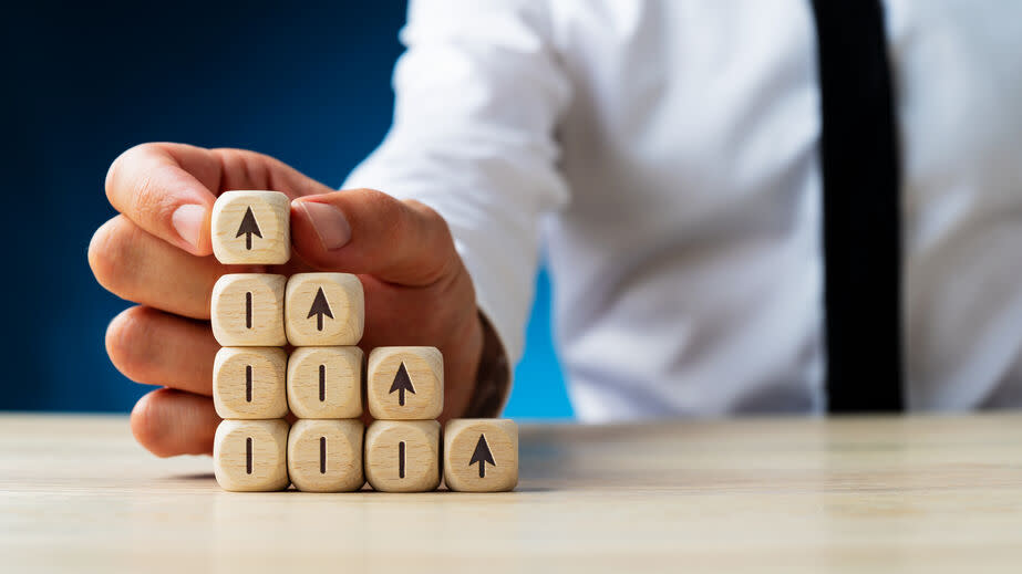 Arrow pointing upwards on wooden dices