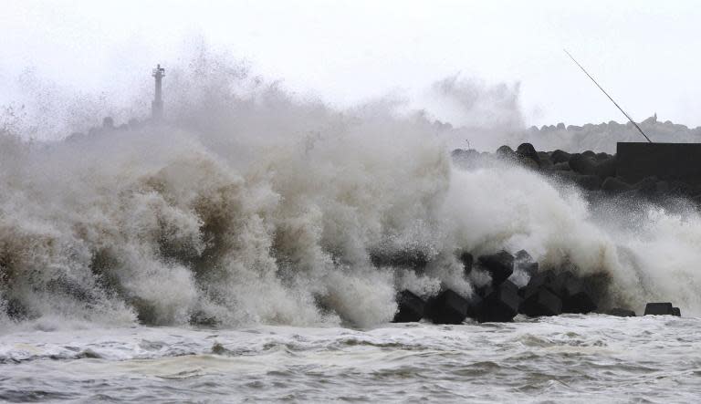 High waves batter a breakwater at the port of Kawaminami, in Miyazaki prefecture, on Japan's southern island of Kyushu on October 13, 2014