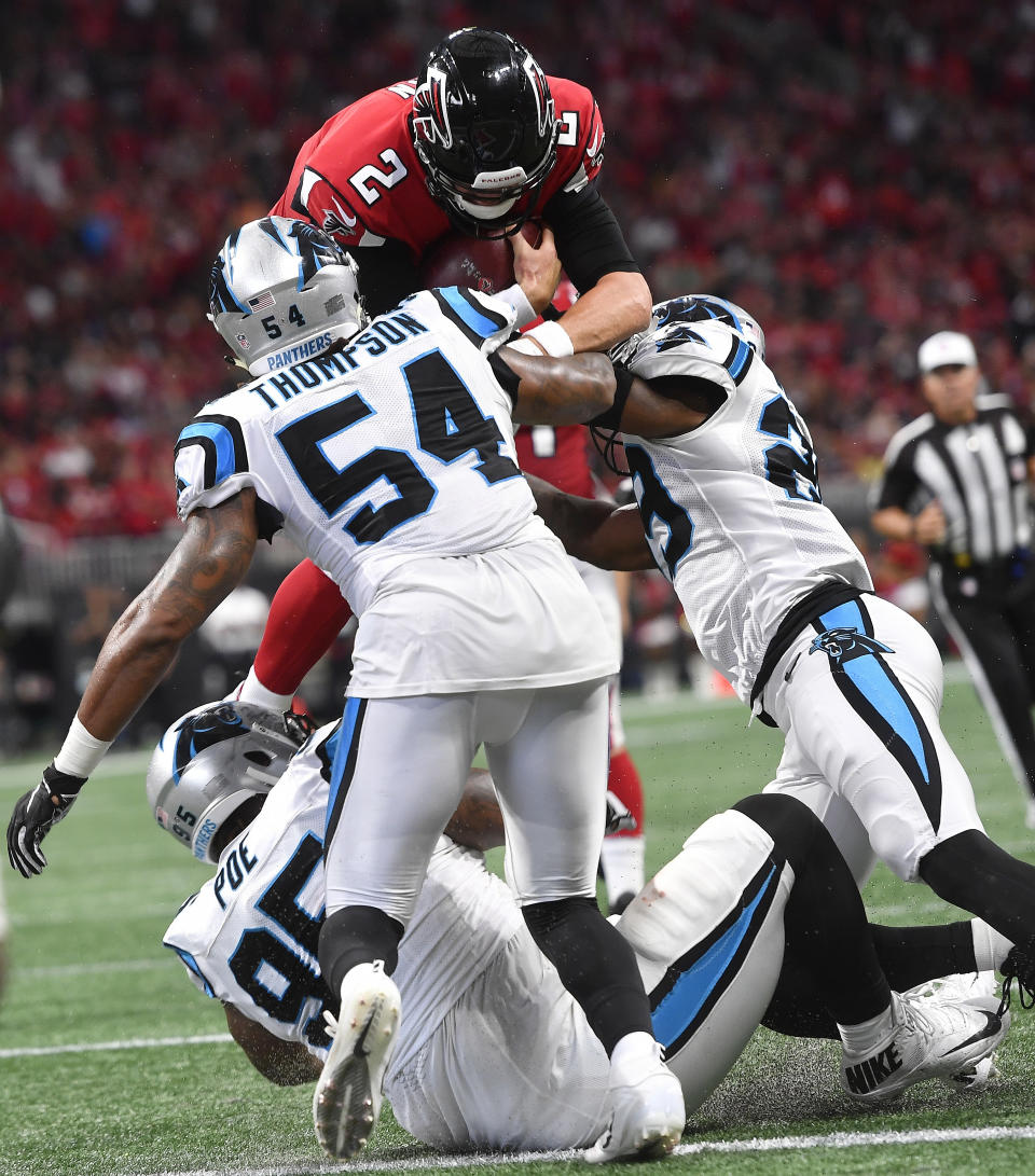 Atlanta Falcons quarterback Matt Ryan (2) leaps for a touchdown as Carolina Panthers linebacker Shaq Green-Thompson (54) defends during the second half of an NFL football game, Sunday, Sept. 16, 2018, in Atlanta. The Atlanta Falcons won 31-24. (AP Photo/John Amis)