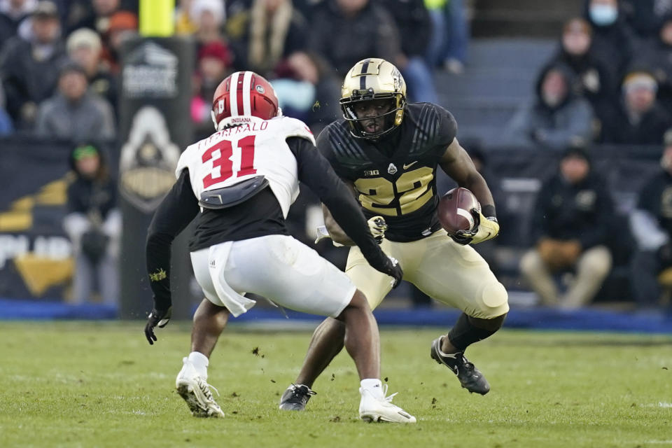 Purdue's King Doerue (22) is tackled by Indiana's Bryant Fitzgerald (31) during the first half of an NCAA college football game, Saturday, Nov. 27, 2021, in West Lafayette, Ind.(AP Photo/Darron Cummings)