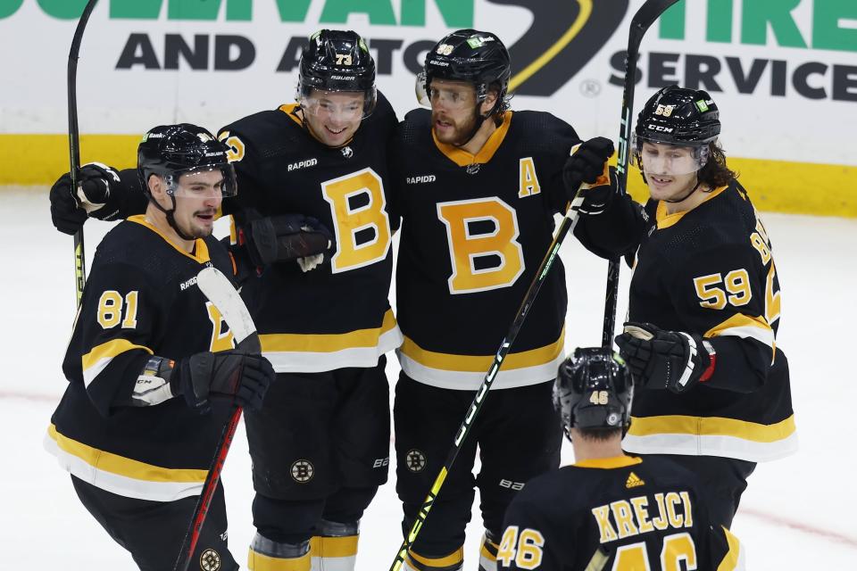 Boston Bruins' David Pastrnak (88) celebrates his goal with Dmitry Orlov (81), Charlie McAvoy (73), Tyler Bertuzzi (59) and David Krejci (46) during the third period of an NHL hockey game against the New York Rangers, Saturday, March 4, 2023, in Boston. (AP Photo/Michael Dwyer)
