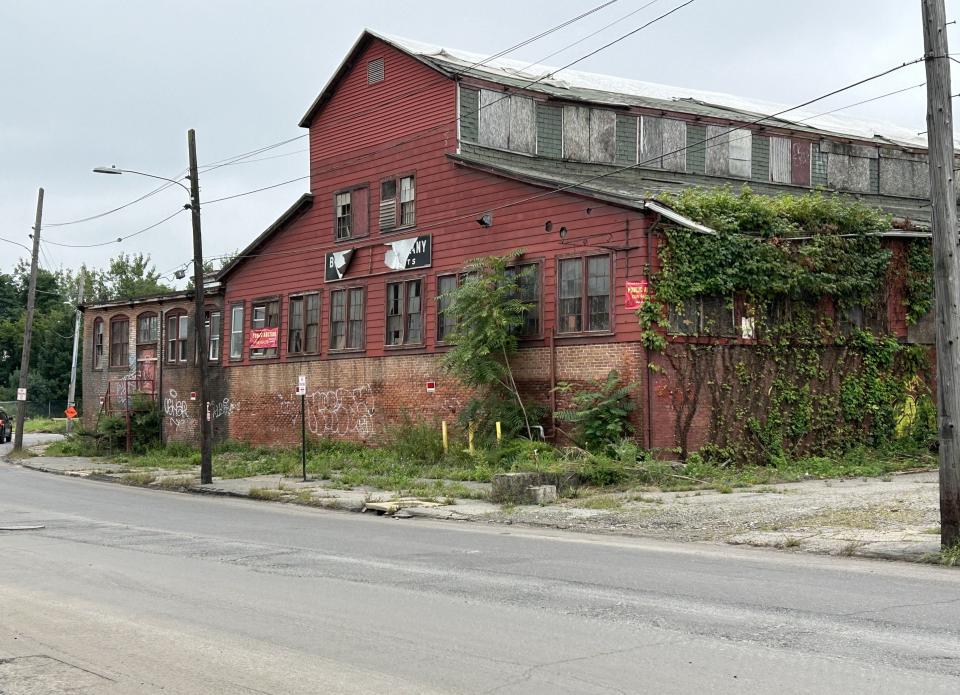 A Weir Village waterfront district proposal includes transforming the vacant Bacon Felt factory into an apartment-retail complex.