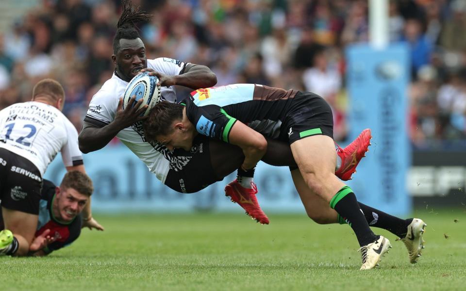 Gabriel Ibitoye of Bristol Bears is tackled by Oscar Beard