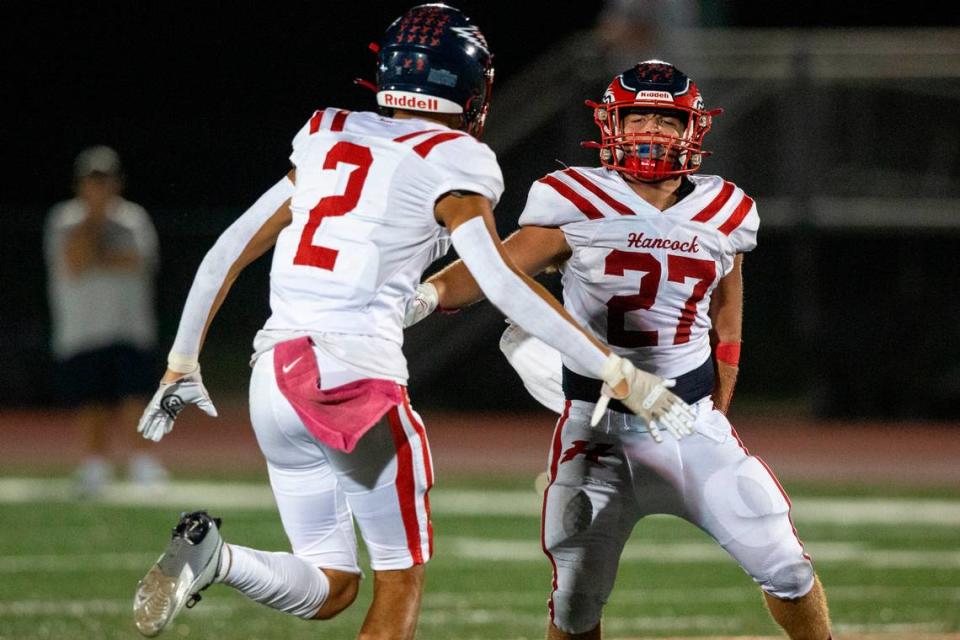 Hancock’s Jeffery Hopgood, right, and Donte Taylor celebrate after a play during a game at West Harrison High School in Harrison County on Friday, Oct. 6, 2023. Hannah Ruhoff/Sun Herald