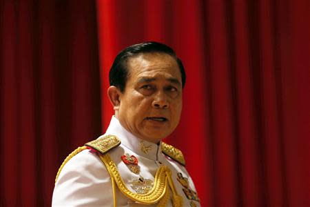 Thai Army chief General Prayuth Chan-ocha looks at reporters after addressing them at the Royal Thai Army Headquarters in Bangkok May 26, 2014. REUTERS/Damir Sagolj