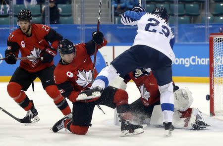 Ice Hockey - Pyeongchang 2018 Winter Olympics - Man’s Quarterfinal Match - Canada v Finland - Gangneung Hockey Centre, Gangneung, South Korea - February 21, 2018 - Karl Stollery of Canada in action with Joonas Kemppainen of Finland. REUTERS/David W Cerny