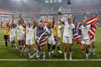 United States' players celebrate with the trophy after winning the Women's World Cup final soccer match between US and The Netherlands at the Stade de Lyon in Decines, outside Lyon, France, Sunday, July 7, 2019. (AP Photo/Claude Paris)