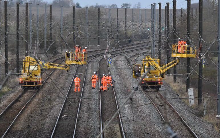 Emergency crews work to restore service on the East Coast main line between Peterborough and Grantham