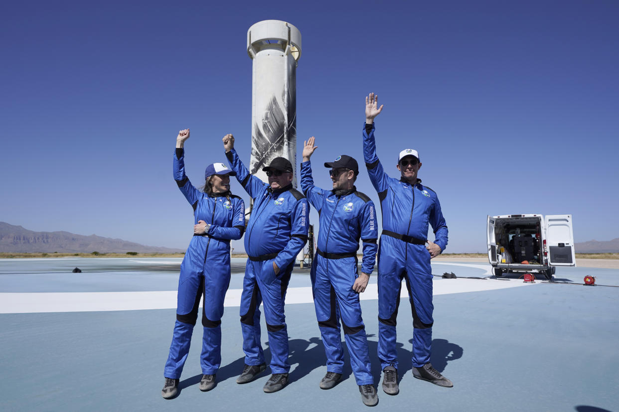 FILE - Blue Origin's New Shepard rocket latest space passengers from left, Audrey Powers, William Shatner, Chris Boshuizen, and Glen de Vries raise their hands during a media availability at the spaceport near Van Horn, Texas, Wednesday, Oct. 13, 2021. Glen de Vries, 49, and Thomas P. Fischer, 54, died in crash of a single-engine Cessna 172 that went down Thursday, Nov. 11, in a wooded area of Hampton Township, N.J. (AP Photo/LM Otero, File)
