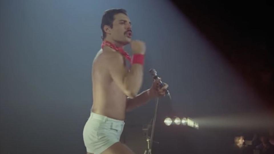 Freddie Mercury rocks out on stage to the Queen classic "We Will Rock You."
