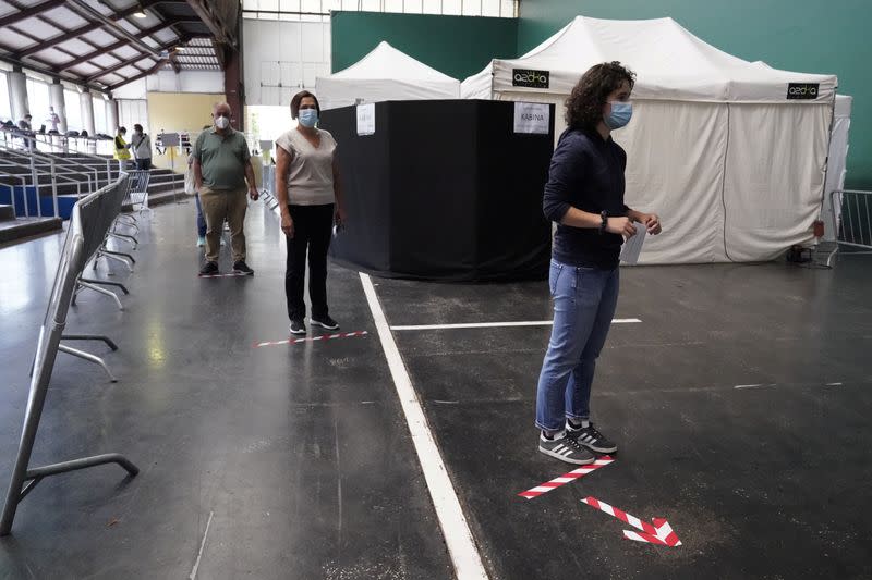 People maintain social distancing before voting during the Basque regional elections, amid the coronavirus disease (COVID-19) outbreak, in Ordizia