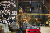 FILE - A client receives a haircut at a barber shop in Istanbul, Turkey, Monday, July 4, 2022. Some 1.6 billion people in 94 countries face at least one dimension of the crisis in food, energy and financial systems, according to a report last month by the Global Crisis Response Group of the United Nations Secretary-General. (AP Photo/Francisco Seco, File)