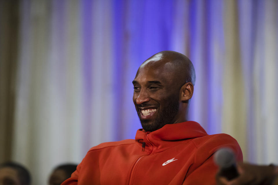 Former Los Angeles Lakers NBA basketball player Kobe Bryant listens to a question as he meets with students at Andrew Hamilton School in Philadelphia, Thursday, March 21, 2019. Kobe Bryant was promoting the book The Wizenard Series: Training Camp he created with writer Wesley King. (AP Photo/Matt Rourke)