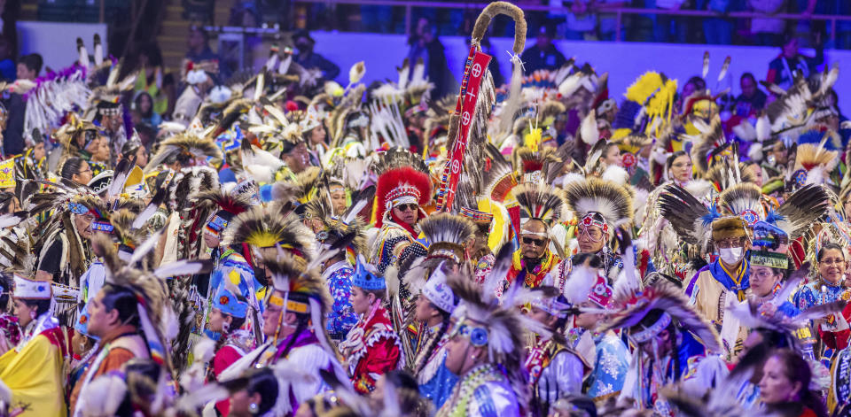 Over a thousand dancers enter the arena for the grand entry at the 40th anniversary of the Gathering of Nations Pow Wow in Albuquerque, N.M., Friday, April 28, 2023. The annual Gathering of Nations kicked off Friday with a colorful procession of Native American and Indigenous dancers from around the world moving to the beat of traditional drums as they fill an arena at the New Mexico state fairgrounds. (AP Photo/Roberto E. Rosales)