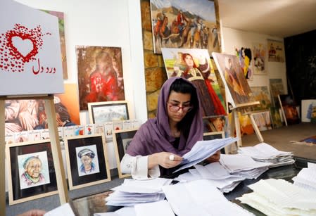 A member of the ArtLords sorts letters of Dard-e-Dil project in Kabul