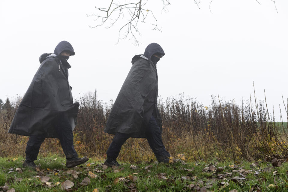 Polish police officers search for missile wreckage in the field, near the place where a missile struck, killing two people in a farmland at the Polish village of Przewodow, near the border with Ukraine, Wednesday, Nov. 16, 2022. (AP Photo/Evgeniy Maloletka)