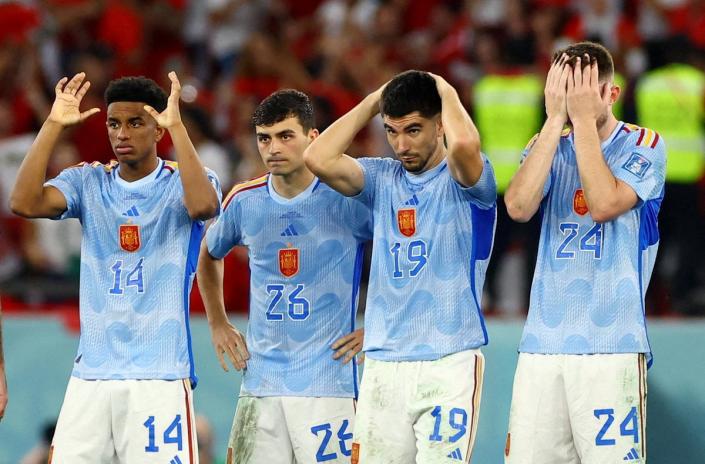 Spain players look dejected after Sergio Busquets has his penalty saved (REUTERS)