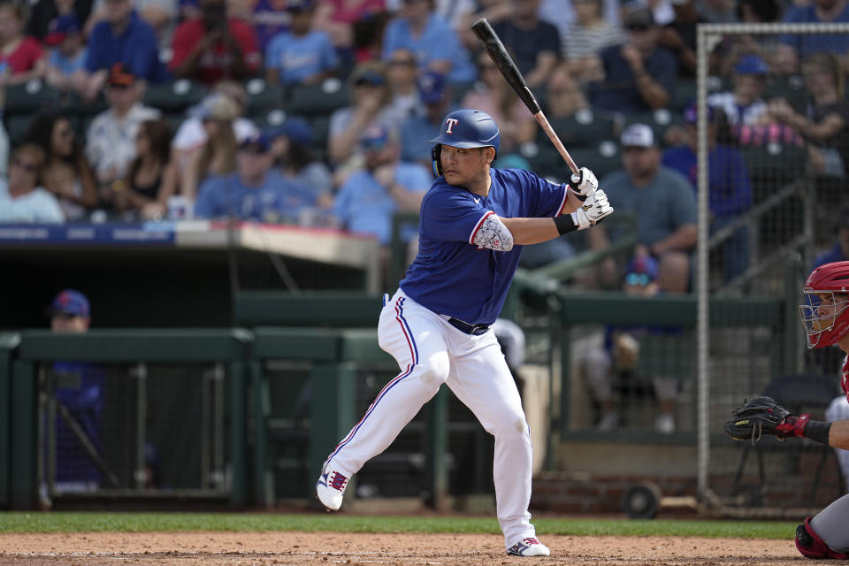 Texas Rangers designated hitter Yoshi Tsutsugo bats during the sixth inning of a spring training baseball game against the Cincinnati Reds, Saturday, March 11, 2023, in Surprise, Ariz. (AP Photo/Abbie Parr)