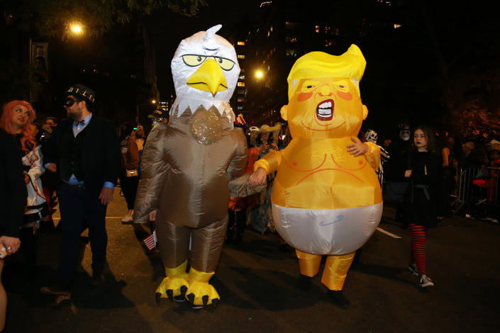 <p>People wear political costumes of Donald Trump and the American eagle to the 45th annual Village Halloween Parade in New York City on Oct. 31, 2018. (Gordon Donovan/Yahoo News) </p>