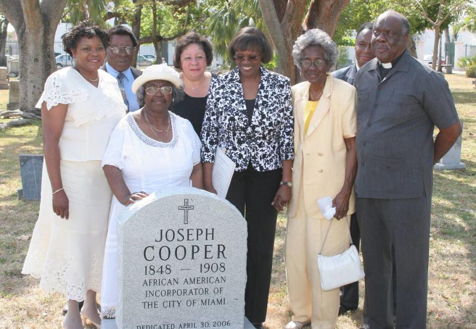 The unveiling of the headstone of Mr. Joseph Cooper at the city of Miami Cemetery. Front, Left to right, Audrey Edmonson, Enid Pinkney, Launita Gaiter, Theodora Cooper,Rev, Preston Marshal. Back, left-right Rev. Robert Holt, Vickie Agustus- Fidelia, Rev. Jesse Marshall.