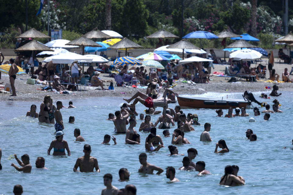 Swimmers enjoy the sea at Glyfada suburb, in Athens, Greece, Saturday, July 15, 2023. Temperatures reached up to 42 degrees Celsius in some parts of the country, amid a heat wave that continues to grip southern Europe. (AP Photo/Yorgos Karahalis)