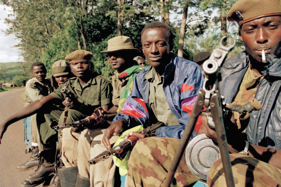 FILE - A pickup truck carries Rwandan Patriotic Front (RPF) rebels to front line positions closer to the capital Kigali, on the road near Rugende, about 5 miles east of Kigali, in Rwanda, May 14, 1994. (AP Photo/Jean-Marc Bouju, File)