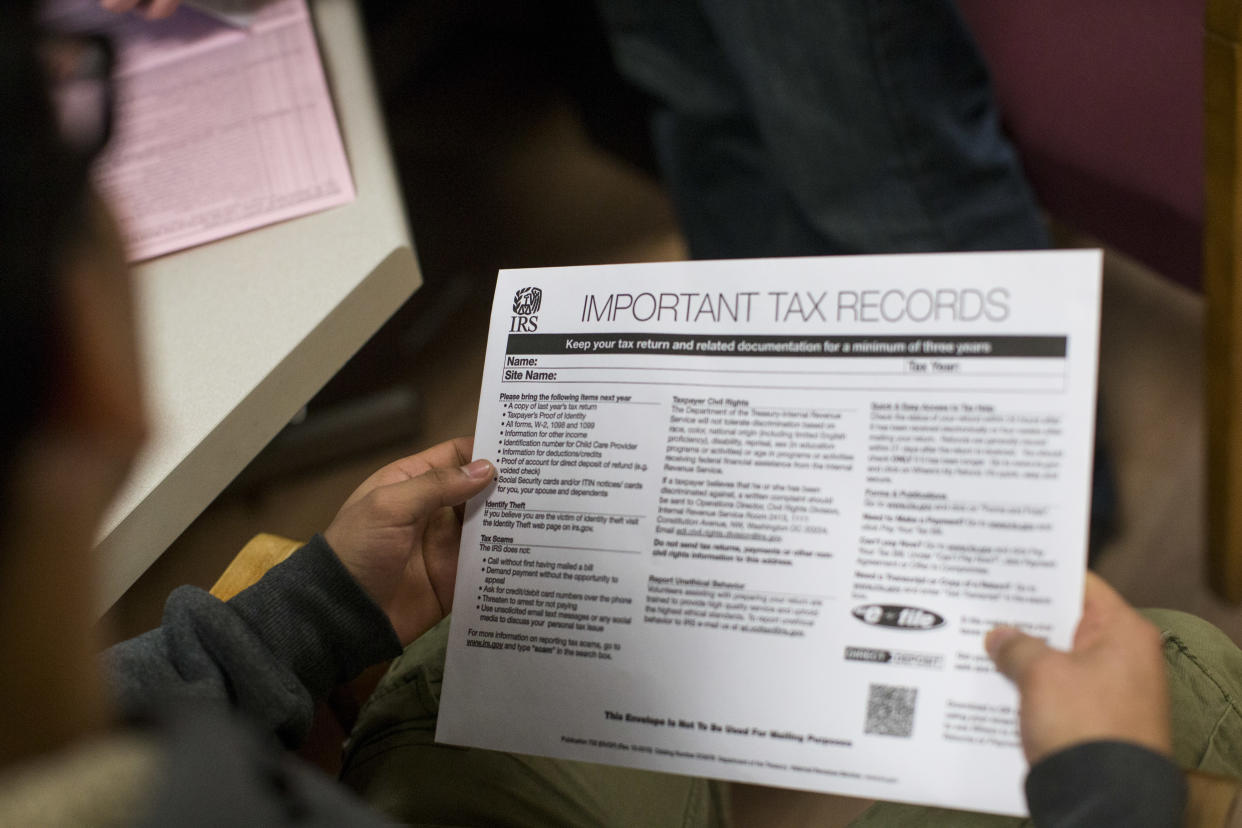 Eduardo Jovel holds his tax return at the Community Economic Development Center in New Bedford, MA. (Credit: Keith Bedford/The Boston Globe via Getty Images)