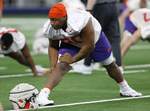 Clemson defensive tackle Dexter Lawrence stretches during team practice at AT&T Stadium in Arlington, Texas, Monday, Dec. 24, 2018. Clemson is scheduled to play Notre Dame in the NCAA Cotton Bowl semi-final playoff Saturday. (AP Photo/Jim Cowsert)