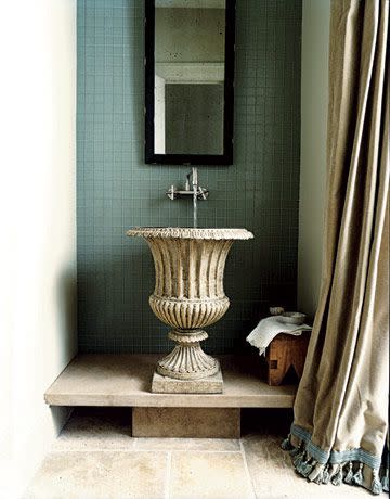 <p>This iron garden ornament was brought indoors by designers Bobby McAlpine and Susan Ferrier. A stone platform raises the urn's inset basin to conventional sink height.</p>