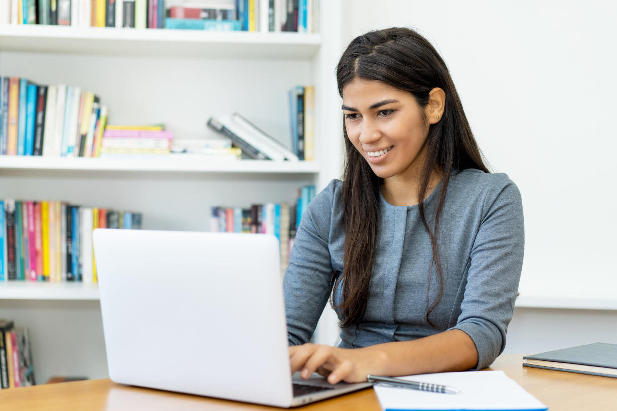 Beautiful south american woman working at computer at office