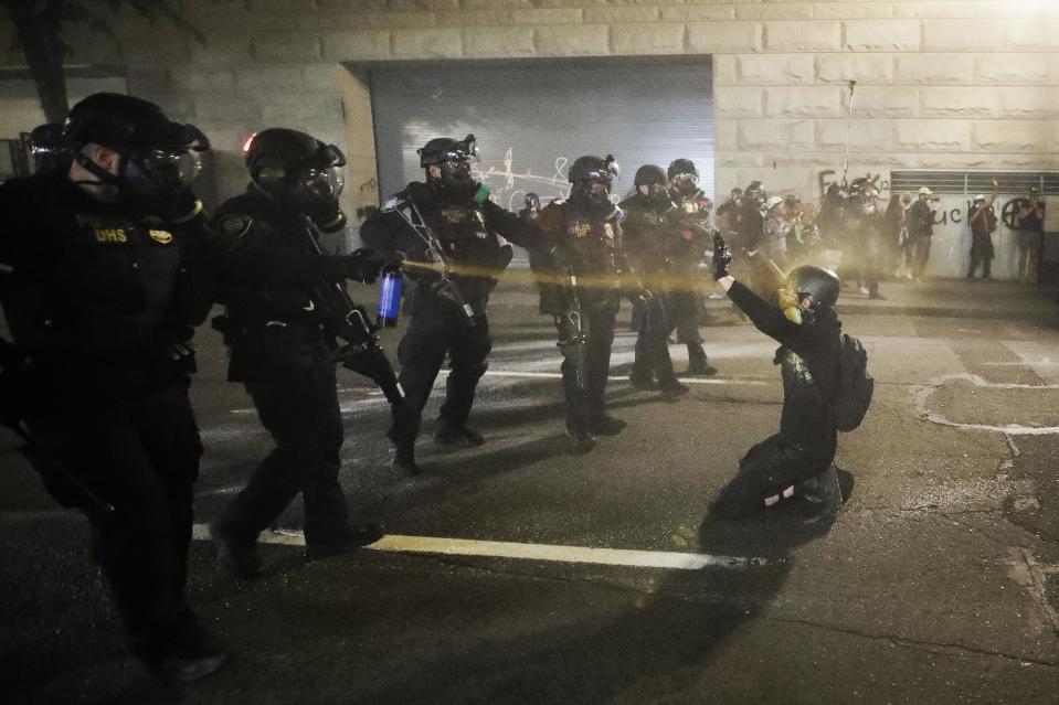 In this July 29, 2020, photo, a demonstrator is pepper sprayed shortly before being arrested during a Black Lives Matter protest at the Mark O. Hatfield United States Courthouse in Portland, Oregon. / Credit: Marcio Jose Sanchez / AP