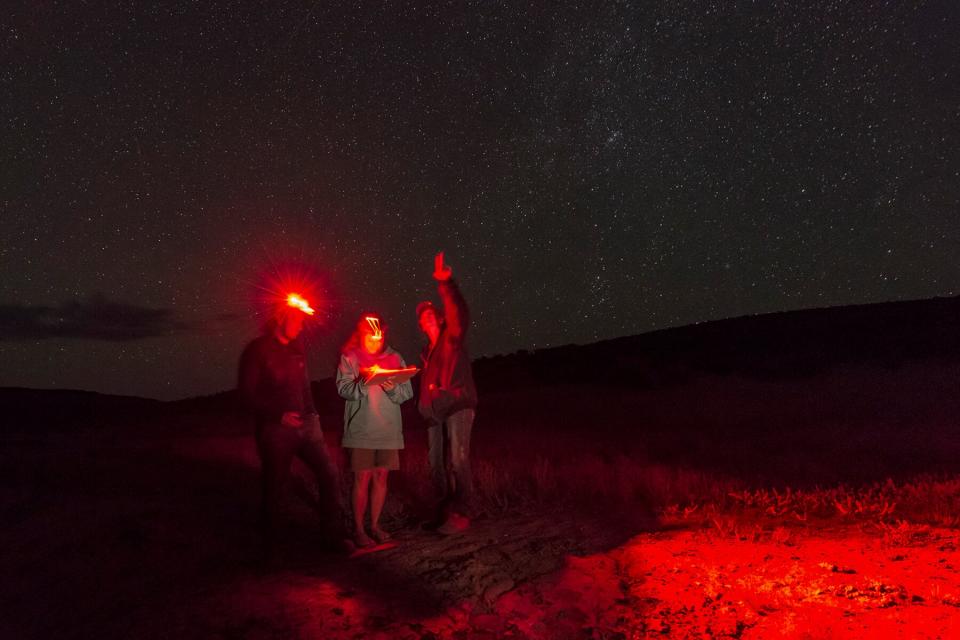 A group of people with headlamps in the Dark Sky Sanctuary in Massacre Rim, Near Reno Tahoe