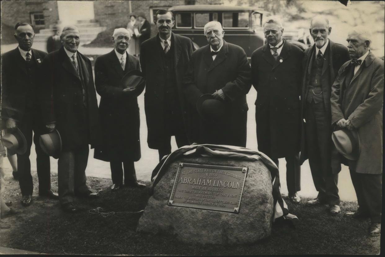 A plaque embedded in stone, marking the spot where Abraham Lincoln spoke at the Wisconsin State Fair in 1859, is dedicated at 13th and Wells streets on Sept. 29, 1928. Those at the dedication included Mayor Daniel Hoan (near center, with dark mustache).