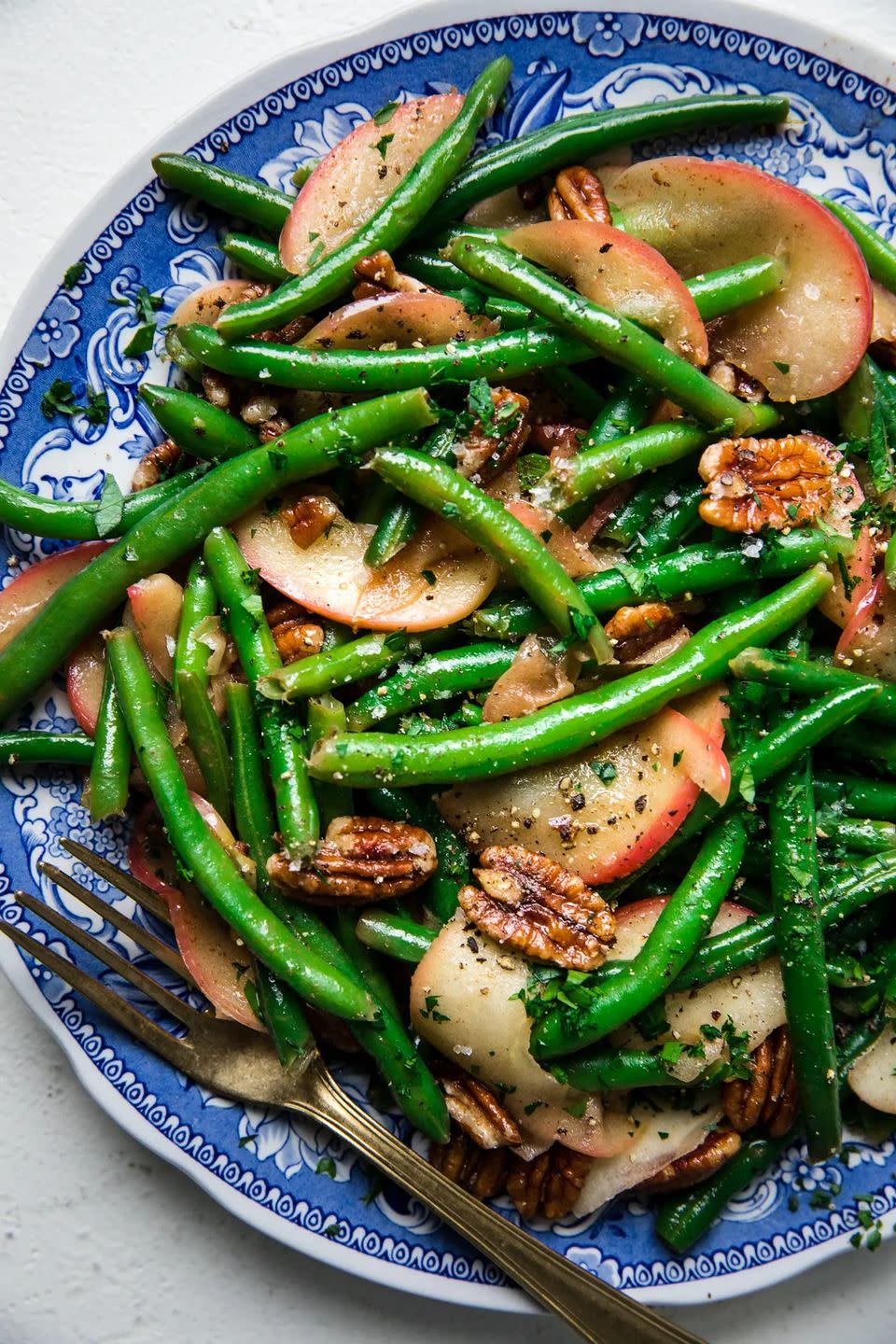 <p>This side dish tosses together green beans with slices of a honeycrisp apple for a delightful flavor combo.</p><p>Get the <strong><a href="https://themodernproper.com/green-beans-with-apples-and-sage-butter" rel="nofollow noopener" target="_blank" data-ylk="slk:Green Beans with Apples and Sage Butter recipe;elm:context_link;itc:0;sec:content-canvas" class="link ">Green Beans with Apples and Sage Butter recipe</a></strong> at The Modern Proper. </p><p><a class="link " href="https://www.amazon.com/Happy-Belly-Pecan-Halves-16/dp/B089HFR93L?tag=syn-yahoo-20&ascsubtag=%5Bartid%7C10070.g.2641%5Bsrc%7Cyahoo-us" rel="nofollow noopener" target="_blank" data-ylk="slk:Shop Pecans;elm:context_link;itc:0;sec:content-canvas">Shop Pecans</a></p>