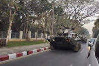 In this image made from video by the Democratic Voice of Burma (DVB), two armored personnel carriers were seen traversing on a road in Yangon, Myanmar, Sunday, Feb. 14, 2021. Sightings of armored personnel carriers in Myanmar’s biggest city and an internet shutdown raised political tensions late Sunday, after vast numbers of people around the country flouted orders against demonstrations to protest the military’s seizure of power. (DVB via AP)