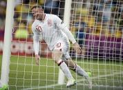 English forward Wayne Rooney celebrates after scoring during the Euro 2012 football championships match England vs Ukraine at the Donbass Arena in Donetsk. Rooney lifted England into the quarter-finals of Euro 2012 on Tuesday with a 1-0 win over co-hosts Ukraine