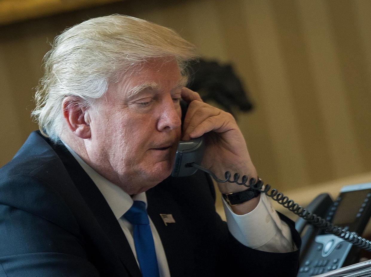 President Donald Trump speaks on the phone with Russian President Vladimir Putin in the Oval Office of the White House: (Getty Images)