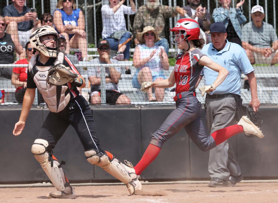 Silver Lake runner Sam Waters scores the games first run beating the throw to Middleboro's Paige Rooney on Saturday, May 13, 2023. 