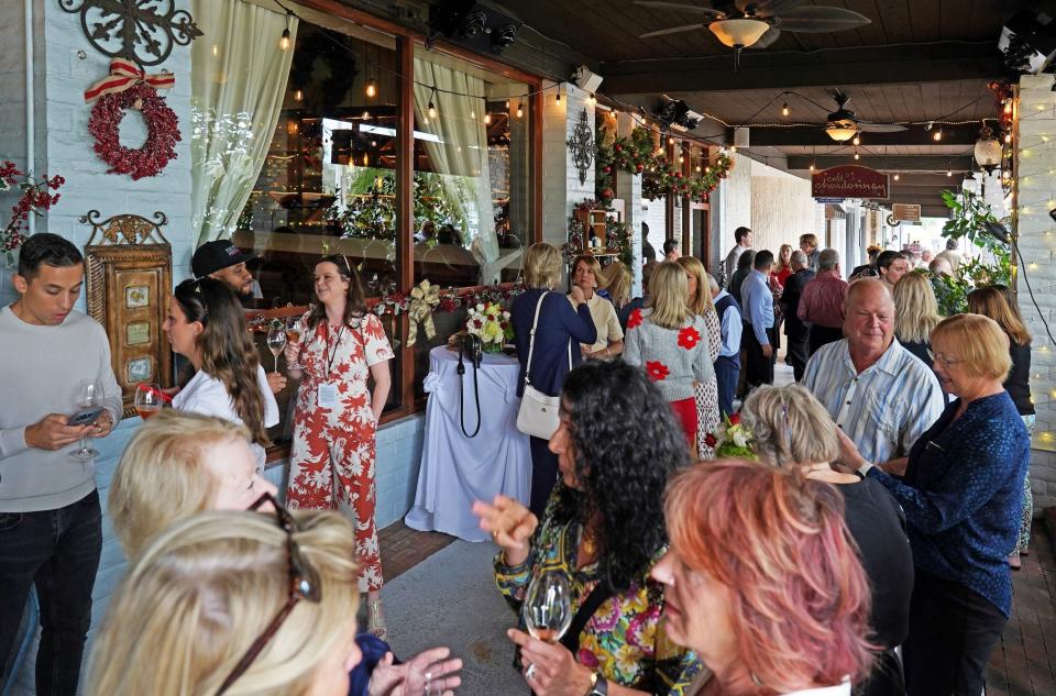 Guests gather outside Café Chardonnay in Palm Beach Gardens for the Palm Beach Food & Wine Festival in December 2023.
