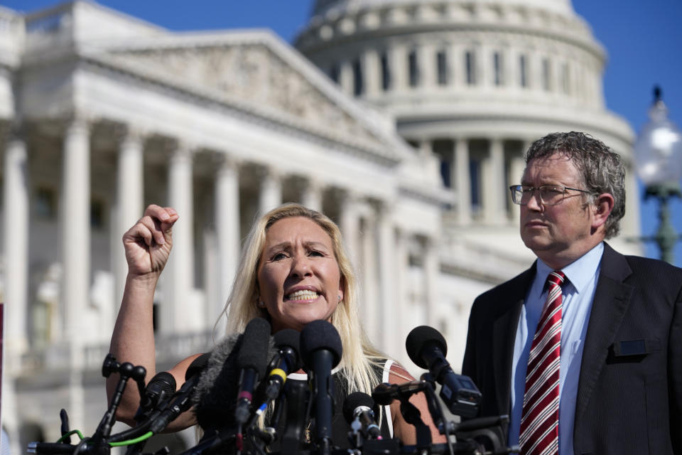 Rep. Marjorie Taylor Greene, R-Ga., joined by Rep. Thomas Massie, R-Ky., says she'll call a vote next week on ousting House Speaker Mike Johnson, R-La., during a news conference at the Capitol in Washington, Wednesday, May 1, 2024. Rep. Greene, a staunch ally of former President Donald Trump, is forcing her colleagues to choose sides after Democratic leaders announced they'd provide the votes to save the Republican speaker's job. (AP Photo/J. Scott Applewhite)