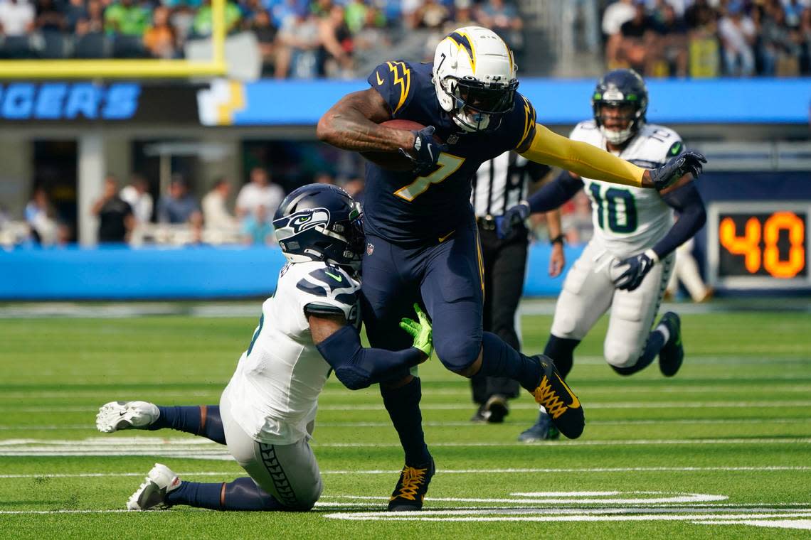 Los Angeles Chargers tight end Gerald Everett (7) runs the ball against Seattle Seahawks safety Quandre Diggs (6) during the first half of an NFL football game Sunday, Oct. 23, 2022, in Inglewood, Calif. (AP Photo/Marcio Jose Sanchez) Marcio Jose Sanchez/AP