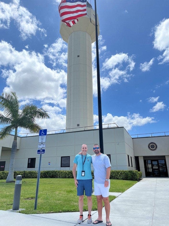 Controller Robert Morgan (left) and a passenger outside of the Palm Beach air traffic control facility. Morgan helped the passenger, who had no flying experience, land a single-engine Cessna safely after an unusual in-flight emergency on May 10, 2022.