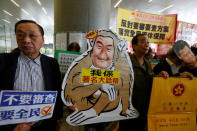 Protesters demanding universal pension mock Hong Kong Chief Executive Leung Chun-ying ahead of Leung's policy address, outside Legislative Council in Hong Kong, China January 18, 2017. REUTERS/Bobby Yip