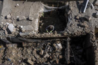 An Afghan man inspects the site of the explosion in a sports club, in the west of Kabul, Afghanistan, Friday, Oct. 27, 2023. The blast killed some people and injured others in a Shiite neighbourhood in the Afghan capital Kabul. (AP Photo/Ebrahim Noroozi)