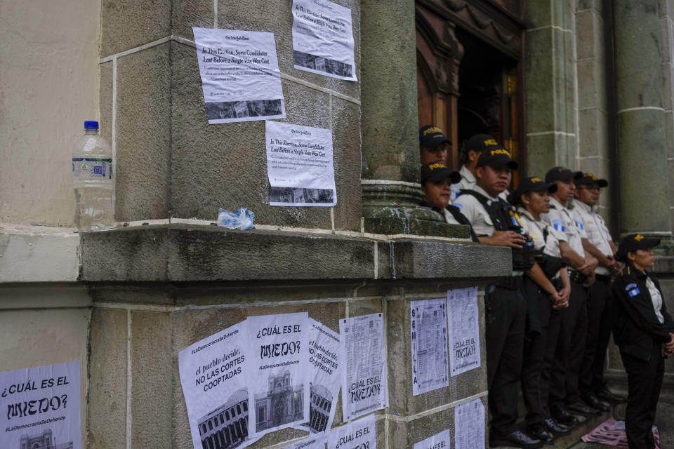 Police stand guard as people protest in front of the Electoral Court building after Guatemala's highest court suspended the releasing of official results of the June 25 general elections, in Guatemala City, Monday, July 3, 2023. (AP Photo/Moises Castillo)