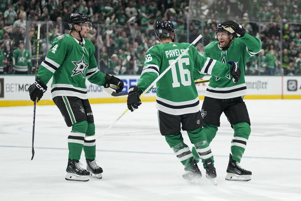 Dallas Stars center Joe Pavelski (16) celebrates his first period goal with Miro Heiskanen, left, and Ryan Suter in Game 5 of an NHL hockey Stanley Cup second-round playoff series against the Colorado Avalanche, Wednesday, May 15, 2024, in Dallas. (AP Photo/Tony Gutierrez)